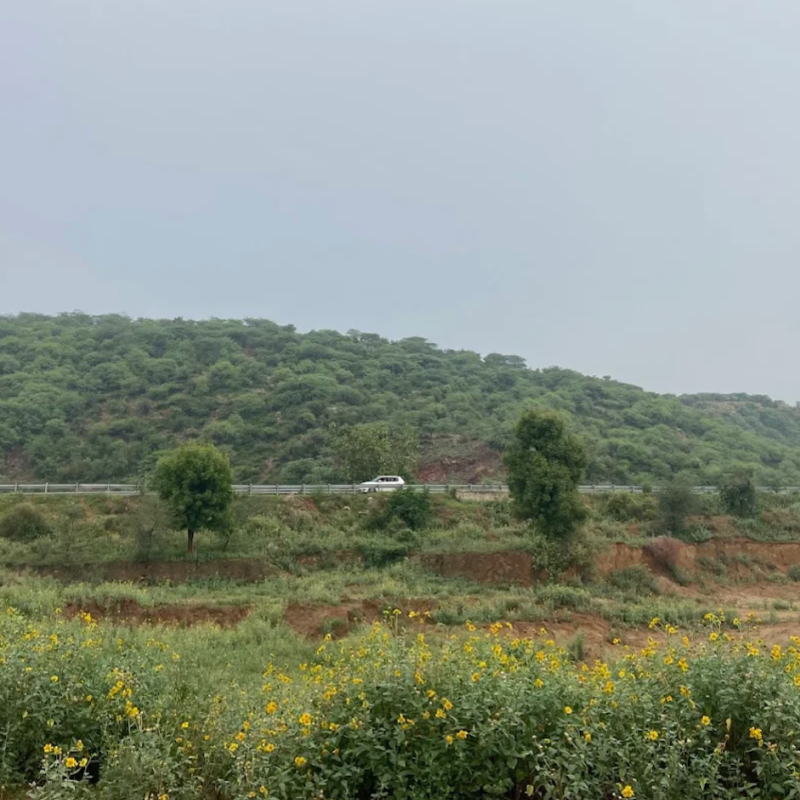 Adventure biker exploring Aravalli Hills trail near Gurgaon, Delhi NCR